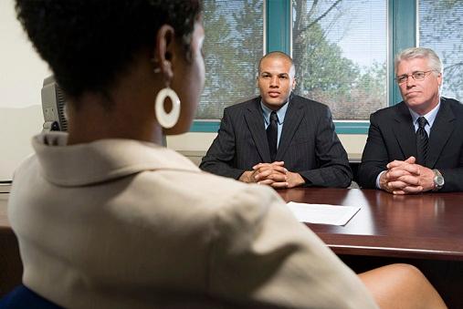 Black woman being Interviewed by one mixed-race man and one white man
