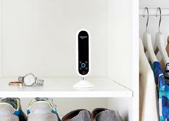 Amazon echo in wardrobe shelf next to watch and clothes in hangers