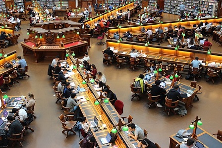University students studying in a large library