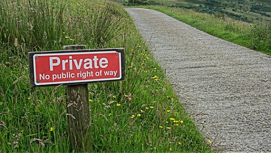 Country road with red sign saying private no public right of way