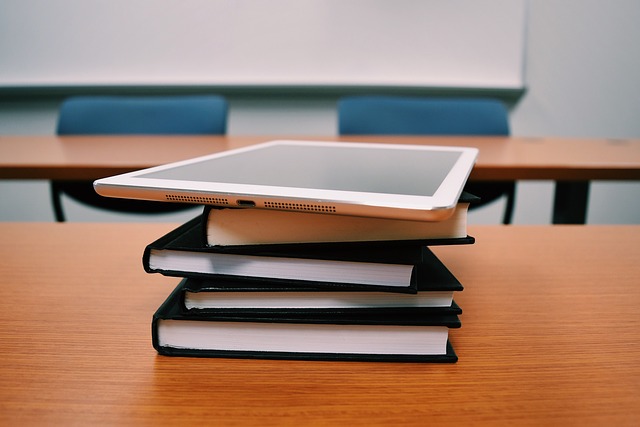 Tablet amd books on a desk in a classroom 